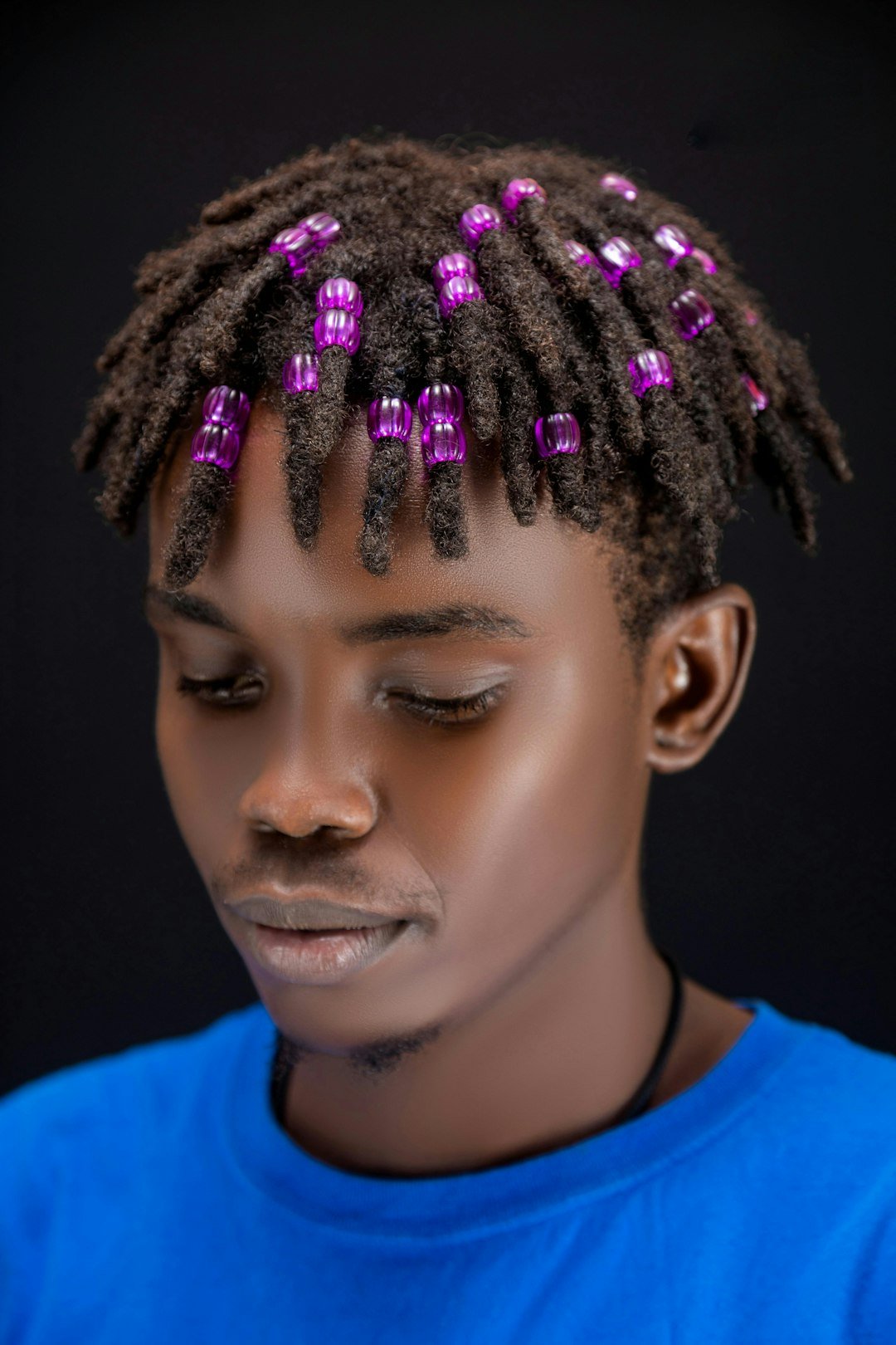 young-man-with-dreadlocks-and-purple-beads-1e1u0-hvyvm